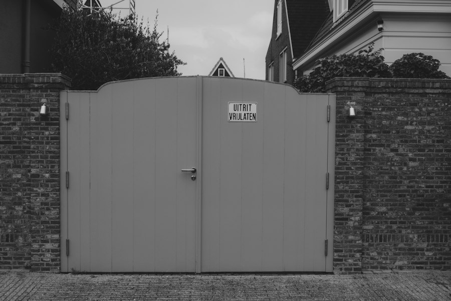 Closed grey double gate in a brick wall